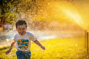 Child in sprinklers