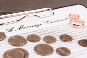 Clipboard with marriage contract and wedding rings