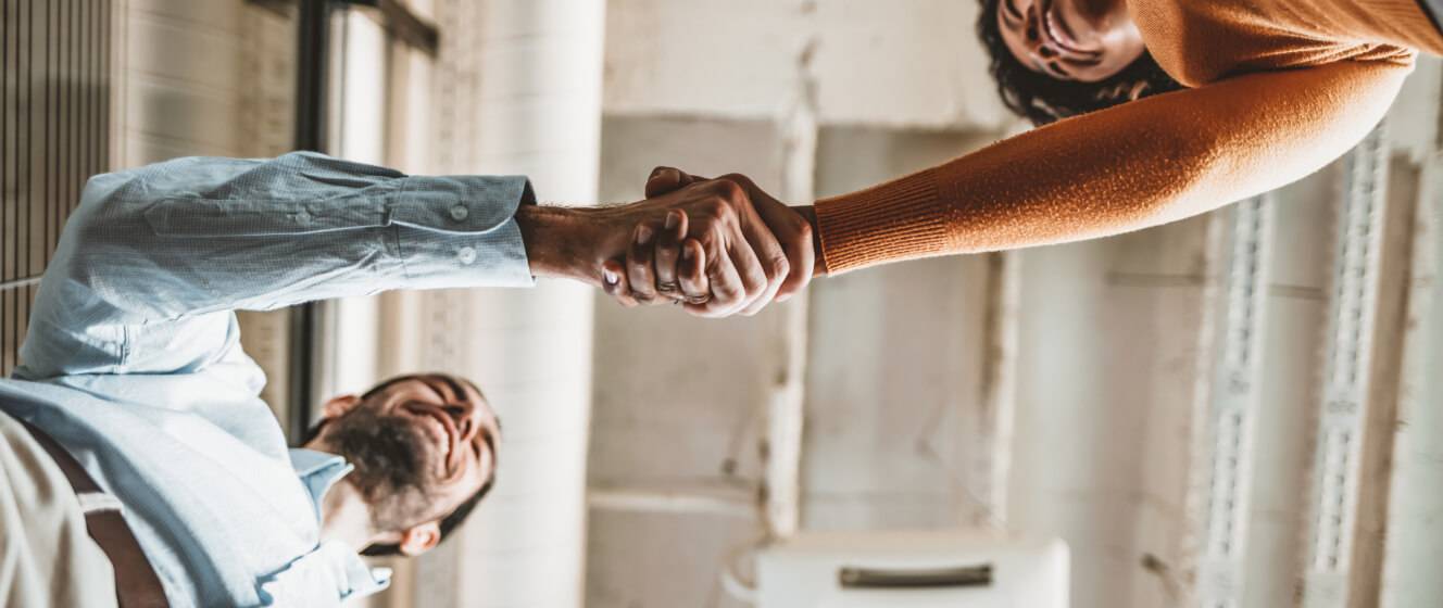 Man and woman shake hands