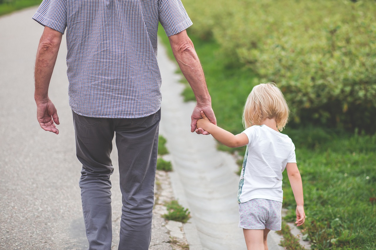 Parent holding child's hand, illustrating parental abduction