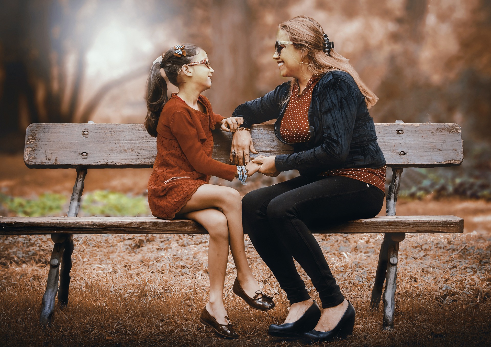 A stepparent and stepchild bonding on a park bench, highlighting the importance of stepparent rights and relationships in California