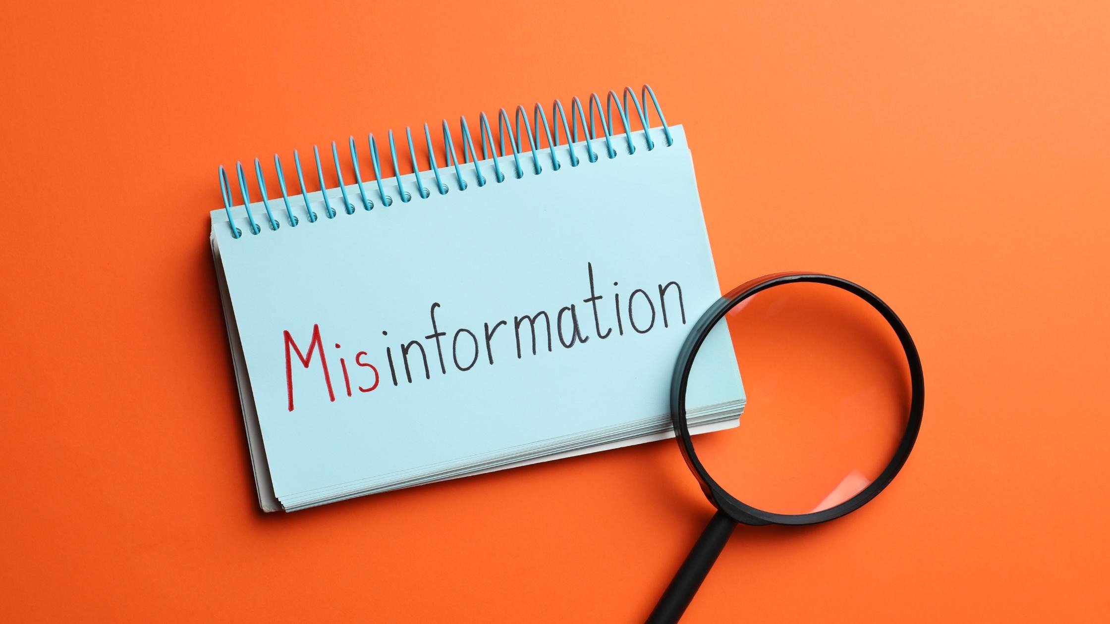 The word 'Misinformation' under a magnifying glass, representing scrutiny of false narratives in legal cases